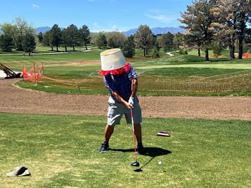 A person playing golf with a bucket of cake on his head

AI-generated content may be incorrect.